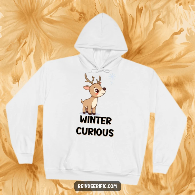 Funny hoodie showing a curious reindeer with head tilted, gazing at a falling snowflake, embodying winter contemplation.